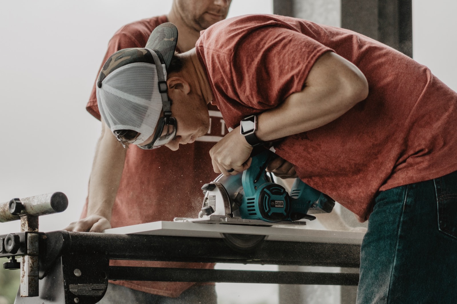 Carpenter cutting a board with a circular saw
